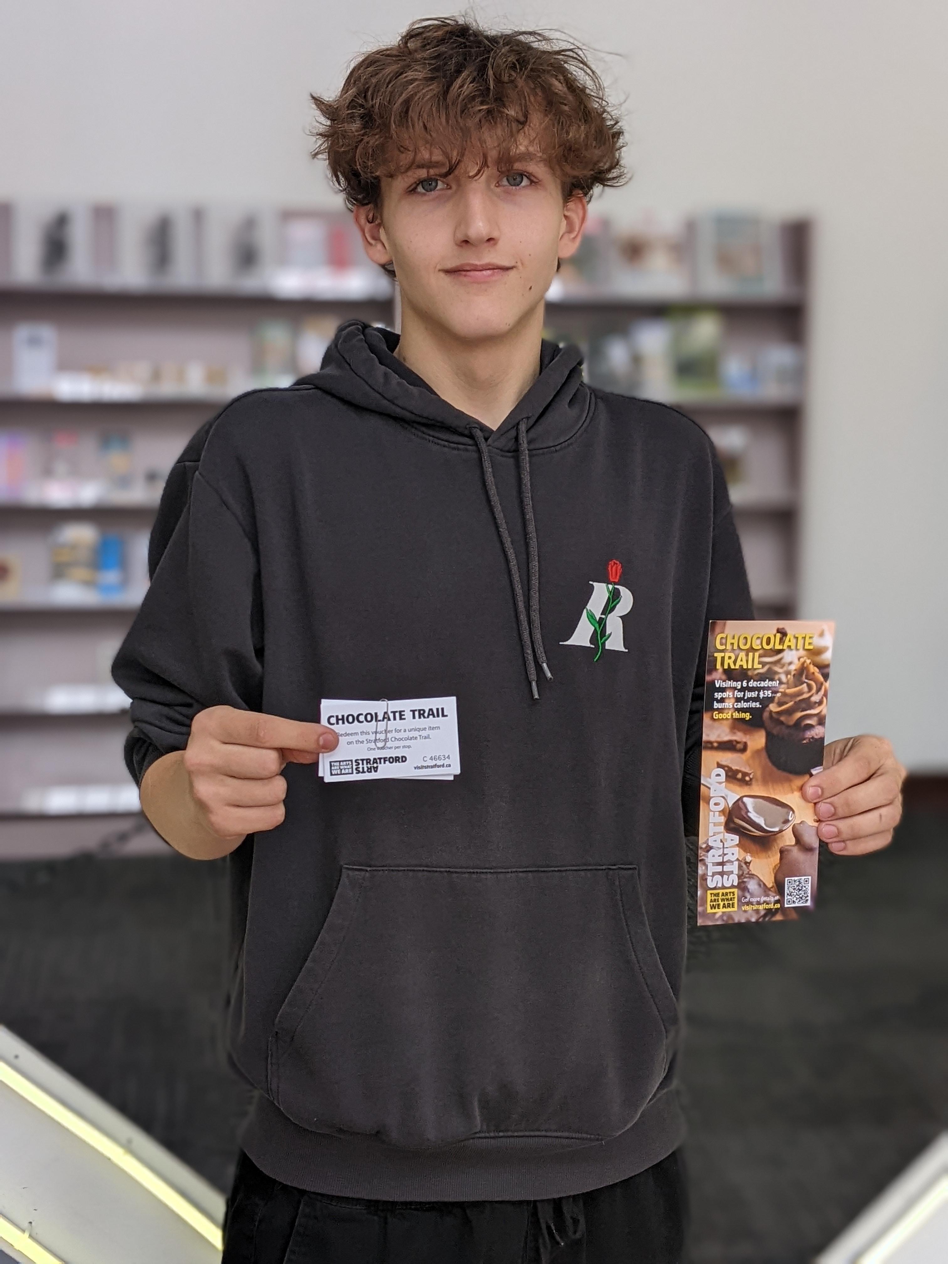 student holding a tourism card