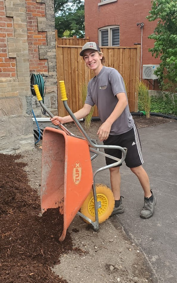 student working with wheelbarrow