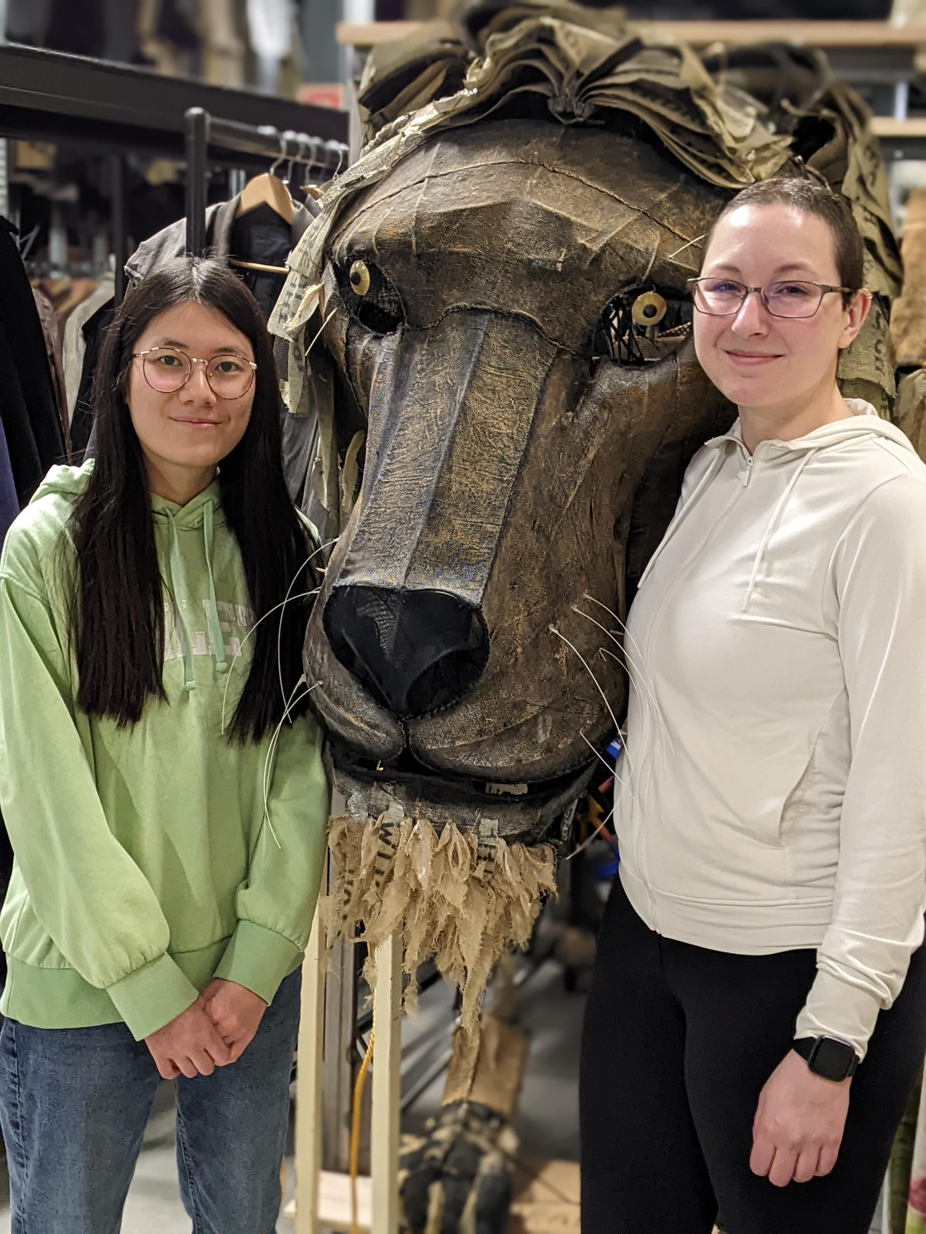 student with employer in front of horse costume