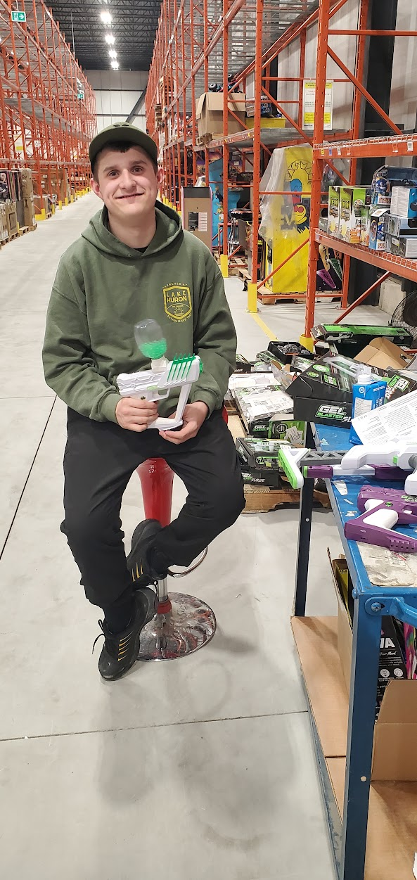 student in warehouse working with games