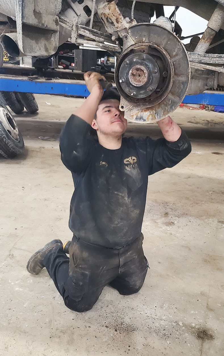 student working under a car